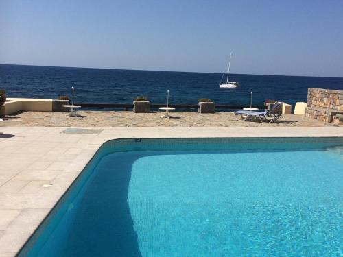 a swimming pool with a view of the ocean at Porto Sisi Hotel Apartments in Sissi
