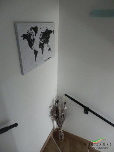 a map of the world hanging on a wall at Il Piccolo B&B in Fiumicino