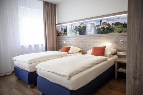 Postel nebo postele na pokoji v ubytování Hotel Ertl