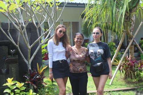 a group of three women standing in a garden at Summer Homestay Bali in Nusa Dua