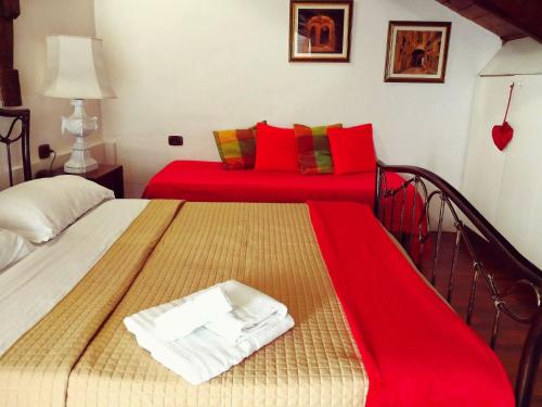 a bedroom with two beds with red pillows at B&B Il Nido Crotone in Crotone