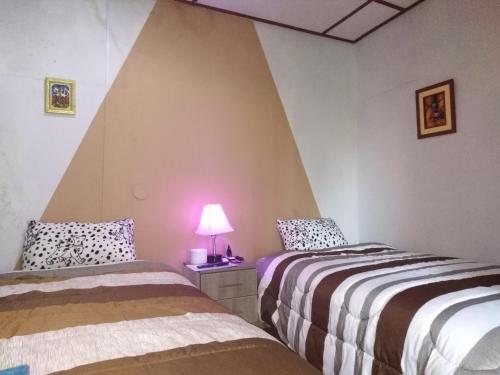 Ένα ή περισσότερα κρεβάτια σε δωμάτιο στο Pousada Villa Huaripampa