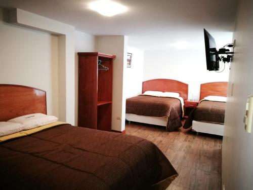 a hotel room with two beds in a room at Posada La Merced in Arequipa