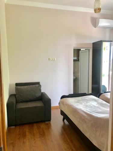 a bedroom with a bed and a couch at 15 Kviparosi Guest House in Makhinjauri