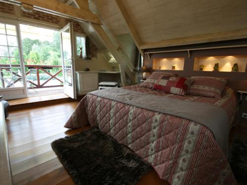 a bedroom with a large bed in a house at Moulin du soustre in Cavagnac