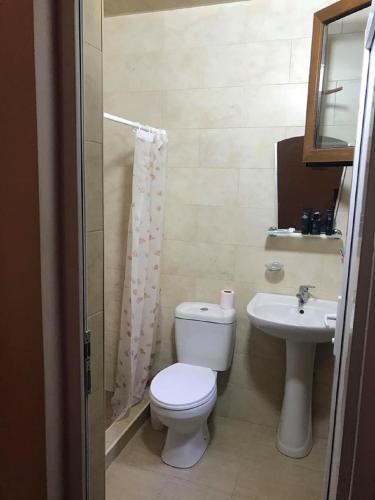 a bathroom with a toilet and a sink at 15 Kviparosi Guest House in Makhinjauri