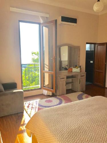 a bedroom with a bed and a dresser and a mirror at 15 Kviparosi Guest House in Makhinjauri
