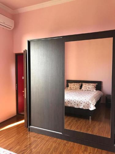 a bedroom with a bed and a large sliding glass door at 15 Kviparosi Guest House in Makhinjauri