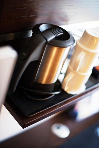 a black and gold coffee maker sitting on a shelf at Havly Hotell in Stavanger