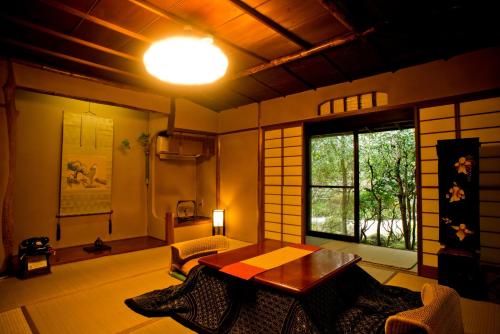 a living room with a table and a window at Yamagaso in Hakone