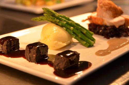 a plate of food with chocolate covered food and asparagus at The Riviera Hotel & Apartments - Alum Chine in Bournemouth
