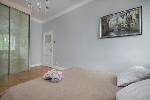 a bedroom with a bed with a stuffed animal on it at Prosta Apartment Old Town in Olsztyn