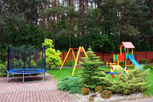 a garden with a playground with a play set at Hotel TiM in Cekanowo