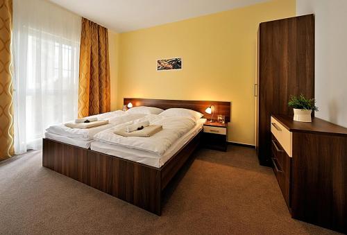 a bedroom with a large bed and a large window at Melrose Apartments in Bratislava