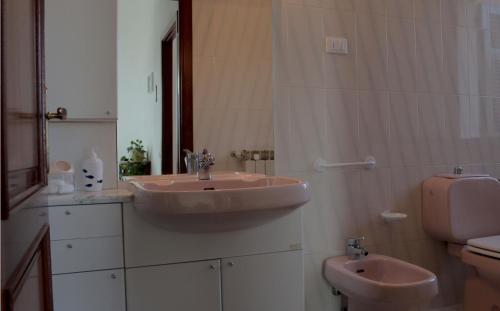 a bathroom with a sink and a toilet at Villa Antonini in Lerici