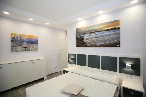 a bedroom with a bed and a painting on the wall at Green Door in Vieste