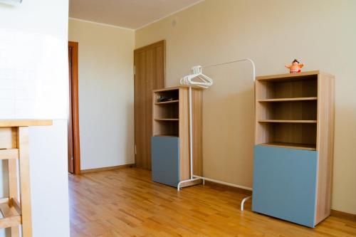 a room with two shelves and a mirror in it at White camomile condo in Šventoji