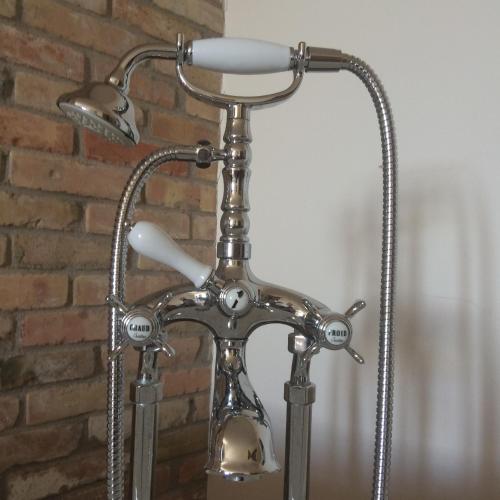a metal lamp with a metal pole and a brick wall at La Locanda Paradiso in SantʼEgidio
