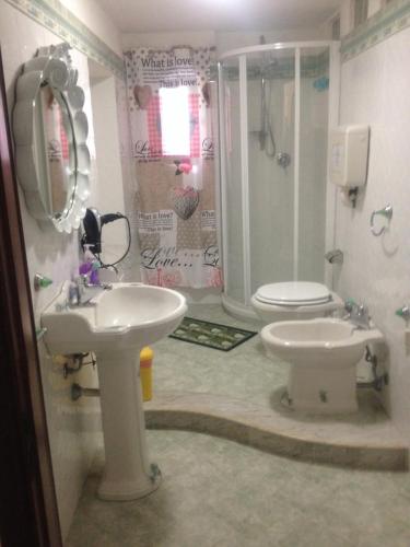 a bathroom with a sink and a shower and a toilet at cara sibilla 112 in Marsala