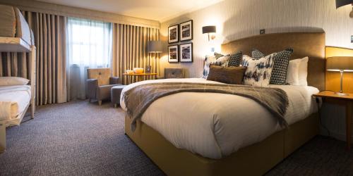 a hotel room with a large bed with pillows at Auchrannie Resort in Brodick