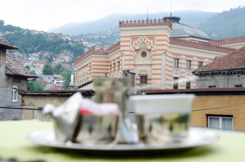 a plate of food on a table in front of a building at Guesthouse Unique in Sarajevo