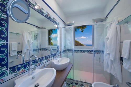 a bathroom with two sinks and a mirror at Hotel Pellegrino in Praiano