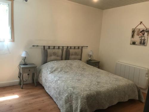 ein Schlafzimmer mit einem großen Bett und zwei Tischen mit Lampen in der Unterkunft A casa nostra in Biguglia