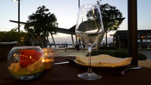 a glass of wine sitting on top of a table at Hotel Belvedere in Venice-Lido