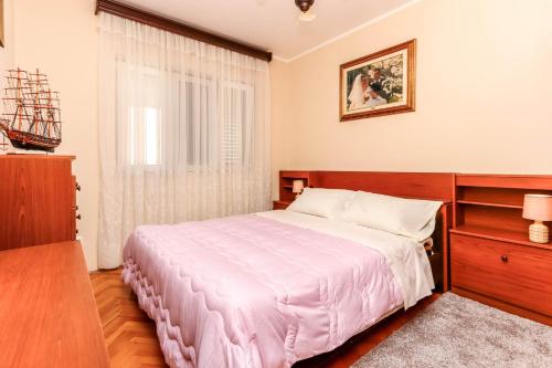 a bedroom with a large bed and a window at Guest House Darka in Bijela