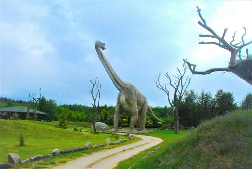 a statue of a giraffe standing in a field at Łeba Apartament in Łeba
