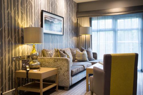 a living room with a couch and a table at Auchrannie Resort in Brodick