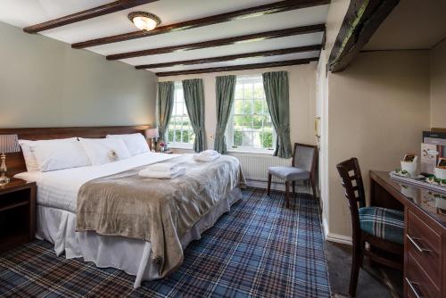 a bedroom with a large bed and a window at The King's Head Inn - The Inn Collection Group in Great Ayton