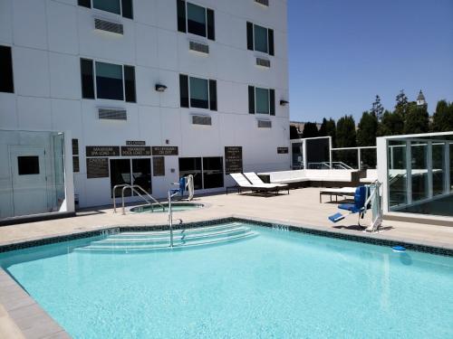 a large swimming pool in front of a building at Wyndham Anaheim in Anaheim