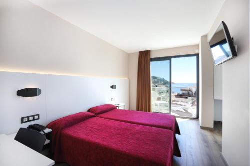 Säng eller sängar i ett rum på Hotel Alameda