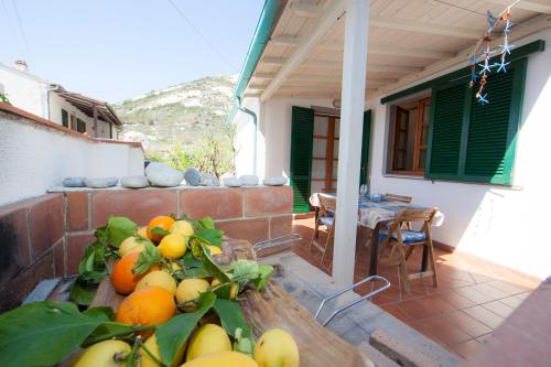 a bunch of fruit sitting on a table on a porch at Casa Danilo in Chiessi