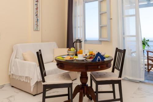 a table with food on it in a living room at Luna Rossa Santorini in Imerovigli