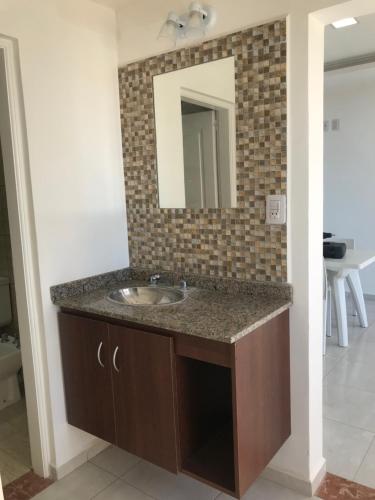 a bathroom with a sink and a mirror at Edificio Tomy in Charata