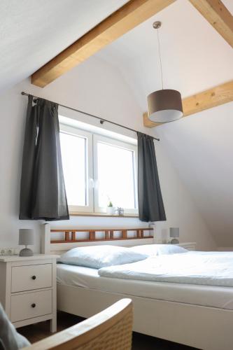 a bedroom with two beds and a window at Ferienhaus am Alfsee in Rieste