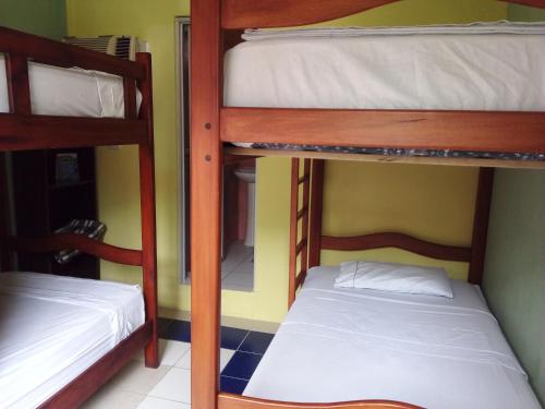 two bunk beds in a room with a mirror at Hostal Surf Olón in Olón