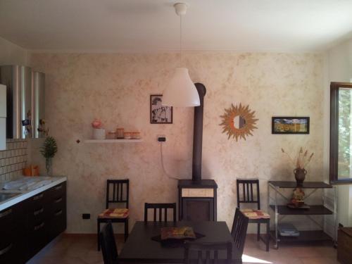 a kitchen with a table and a stove in a room at Casa Bellavista in Viggianello