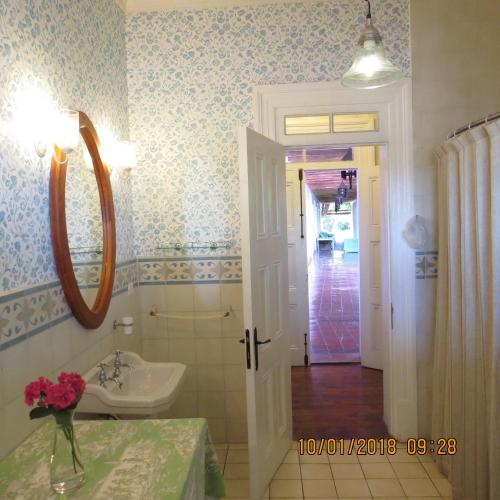 a bathroom with a sink and a mirror at Hotel Boutique Quinta Maria in Santa Cruz