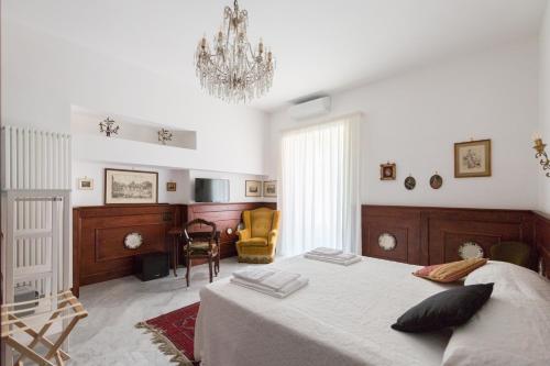 una camera con letto e lampadario a braccio di Palazzo Doria d'Angri a Napoli