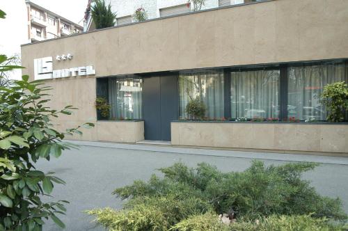 a building with a sign on the side of it at Hotel Lis in Asti