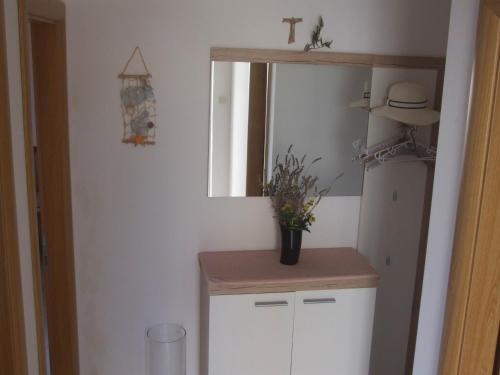 a kitchen with a white refrigerator and a mirror at Villa Mandina in Sevid