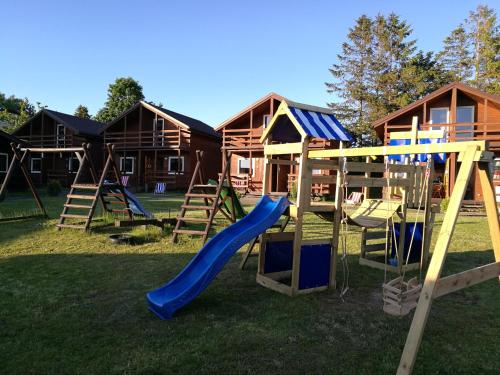 a playground with a slide in a yard at Osada Rybacka in Jastrzębia Góra