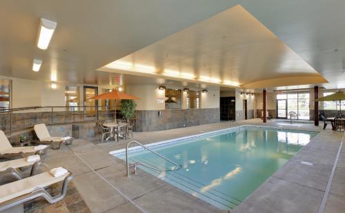 a large swimming pool in a building with a restaurant at StoneCreek Lodge in Missoula