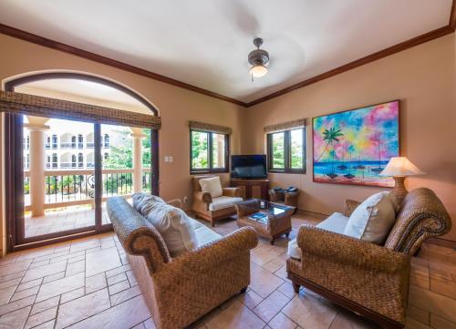 a living room with two couches and a tv at Coco Beach Resort in San Pedro