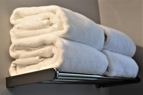 a stack of towels sitting on top of a towel rack at Simply Luxury Stays in Ottawa