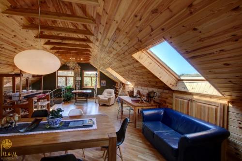 a living room with a blue couch and a wooden ceiling at Pilava in Roja