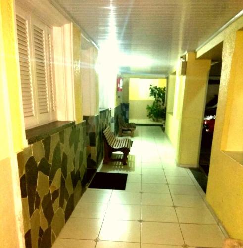 a hallway with a bench in a building at Petit Rivera Hotel in Rivera